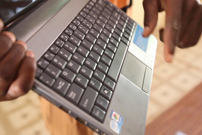 A laptop computer held by a student ar the Gbimsi Junior High School, in Savelugu, Northern Region of Ghana. May 2016. Credit: GPE/Stephan Bachenheimer